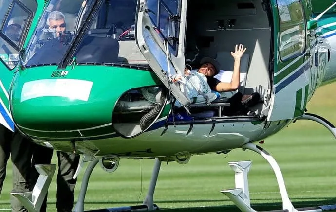 Neymar acena de dentro do helicóptero antes de deixar a Granja Comary; jogador está fora da Copa