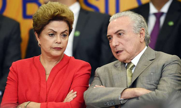 Brazilian President Dilma Rousseff and her vice President Michel Temer attend the launching ceremony of the Logistics Investment Program (LIP), at the Planalto Palace in Brasilia, on June 9, 2015. Brazil announced a $64-billion infrastructure spending package on Tuesday, hoping to revive its flagging economy with investment in highways, railroads, ports and airports.     AFP PHOTO/EVARISTO SA