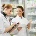 two pharmacist chemist women working in pharmacy drugstore