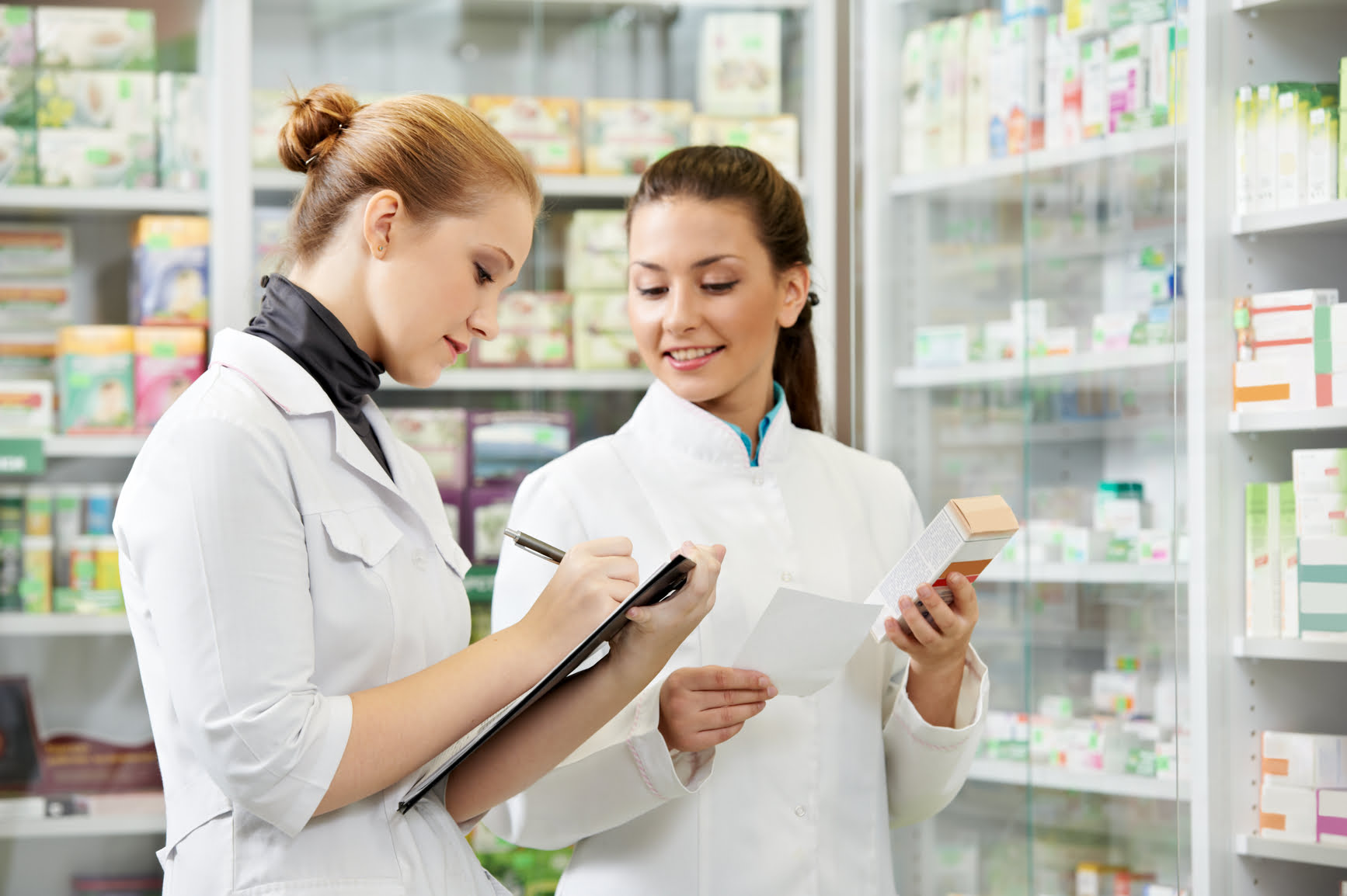two pharmacist chemist women working in pharmacy drugstore