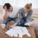 Depressed couple doing their accounting in their living room