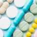Opioid painkillers crisis and drug abuse concept. Opioid and prescription medication addiction epidemic. Different kinds of multicolored pills. Pharmaceutical medicament background