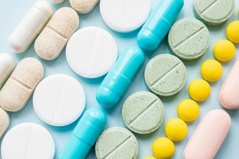 Opioid painkillers crisis and drug abuse concept. Opioid and prescription medication addiction epidemic. Different kinds of multicolored pills. Pharmaceutical medicament background