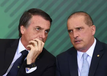 Brazilian President Jair Bolsonaro (L) talks to Chief of Staff Onyx Lorenzoni during the appointment ceremony of the new heads of public banks, at Planalto Palace in Brasilia on January 7, 2019. - Brazil's Finance Minister Paulo Guedes appointed the new presidents of the country's public banks. (Photo by EVARISTO SA / AFP)