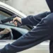 side view of car thief in action