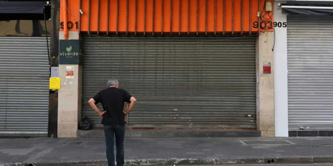 A man is seen in front of closed stores after the city's government decreed the closure of shops and stores as a precautionary measure against coronavirus disease (COVID-19) in downtown Sao Paulo, Brazil, March 20, 2020. REUTERS/Amanda Perobelli
