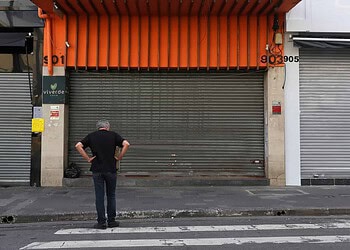 A man is seen in front of closed stores after the city's government decreed the closure of shops and stores as a precautionary measure against coronavirus disease (COVID-19) in downtown Sao Paulo, Brazil, March 20, 2020. REUTERS/Amanda Perobelli