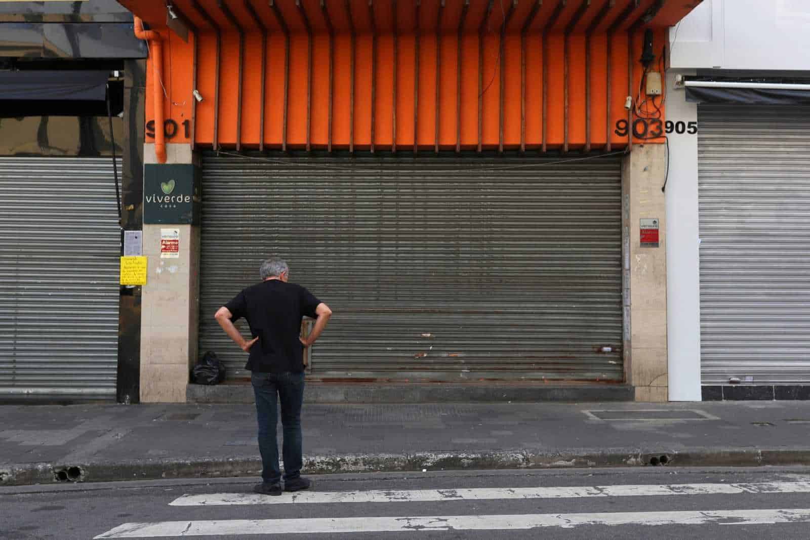 A man is seen in front of closed stores after the city's government decreed the closure of shops and stores as a precautionary measure against coronavirus disease (COVID-19) in downtown Sao Paulo, Brazil, March 20, 2020. REUTERS/Amanda Perobelli