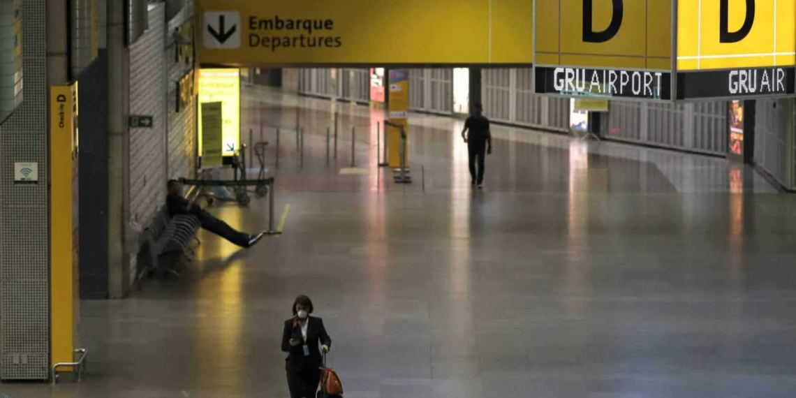 A flight attendant, wearing a protective face mask, walks at Guarulhos International Airport amid fears of coronavirus disease (COVID-19) in Guarulhos, Sao Paulo state, BraziI, April 1, 2020. REUTERS/Roosevelt Cassio