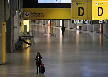 A flight attendant, wearing a protective face mask, walks at Guarulhos International Airport amid fears of coronavirus disease (COVID-19) in Guarulhos, Sao Paulo state, BraziI, April 1, 2020. REUTERS/Roosevelt Cassio