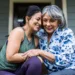 Senior woman and adult daughter laughing on porch