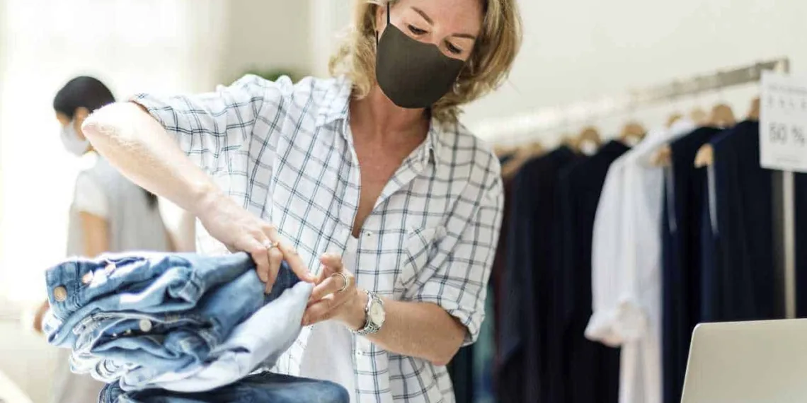New normal in retail, business owner wearing a mask