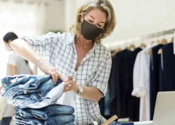 New normal in retail, business owner wearing a mask