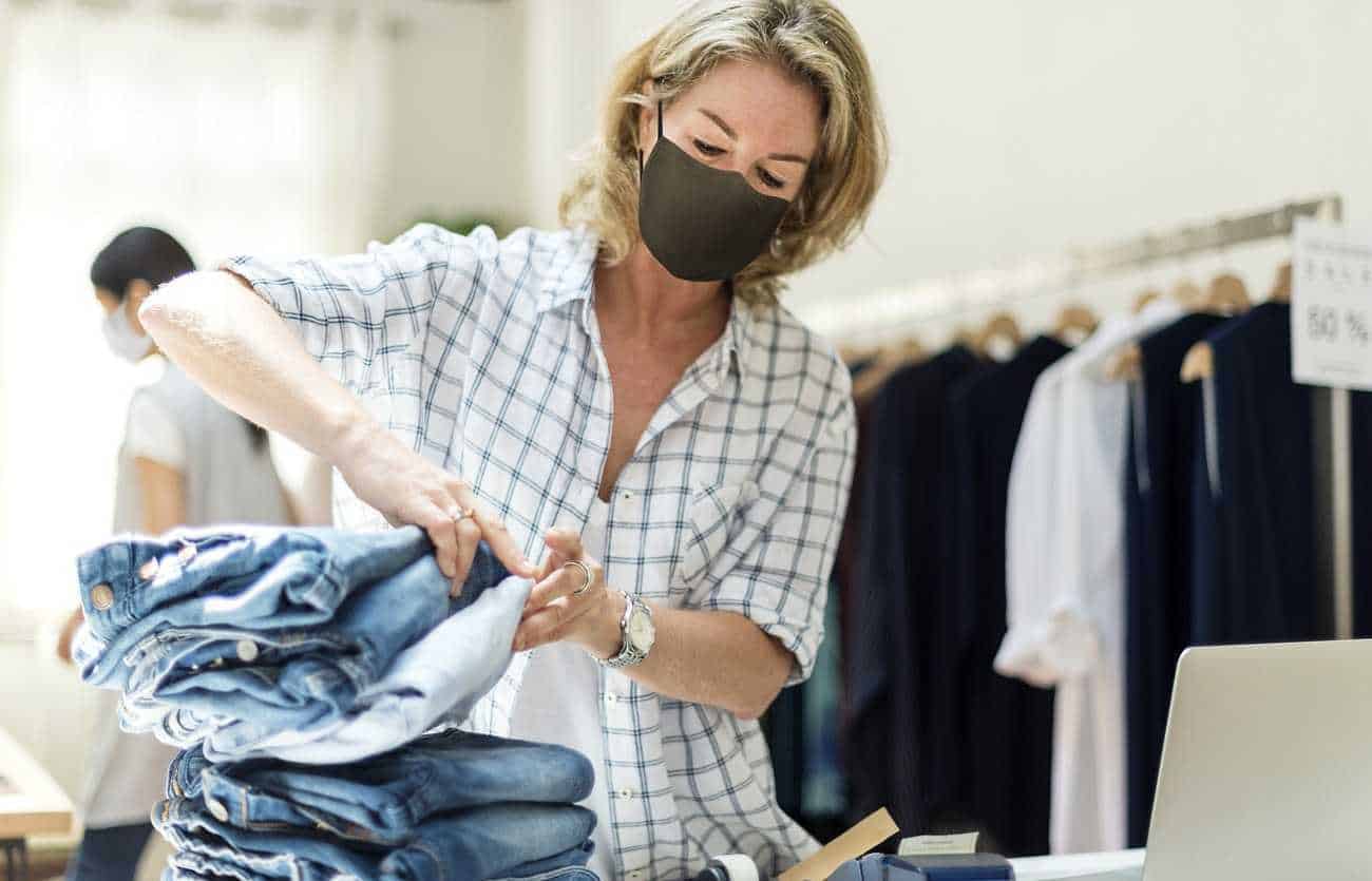 New normal in retail, business owner wearing a mask