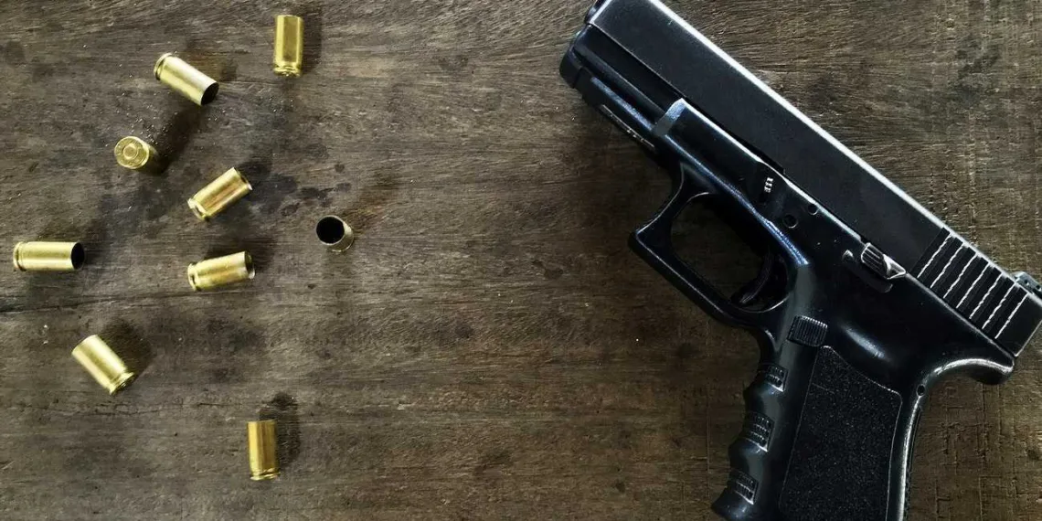 Empty bullets and a gun on at table