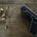Empty bullets and a gun on at table
