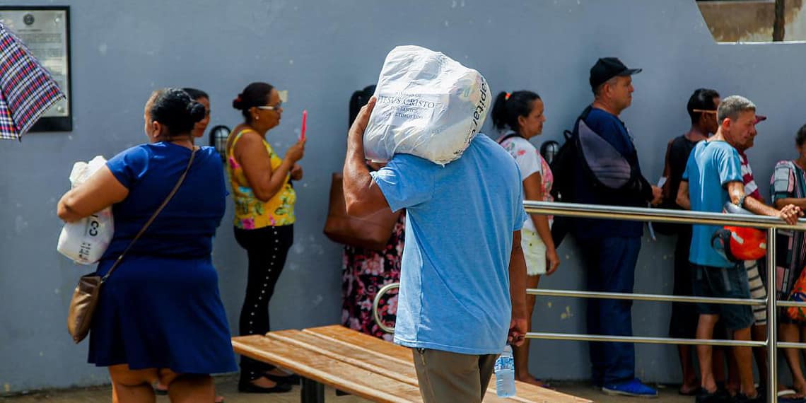 Famílias atingidas pelas enchentes recebem cestas básicas no Casarão. Foto: Neto Lucena/Secom