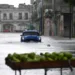 An old American car drives through a flooded street in Havana, on Augusto 29, 2023, during the passage of tropical storm Idalia. Tropical Storm Idalia strengthened into a hurricane this Tuesday and forecasters are forecasting it to become "extremely dangerous" before making landfall on Wednesday in Florida, US. (Photo by Yamil LAGE / AFP)