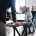 Man have a question. Hand raised up. Group of people at business conference in modern classroom at daytime.