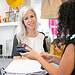 Positive fashion store customer paying for purchase at checkout, looking at pos terminal and cashier hands. Medium shot, copy space. Shopping concept