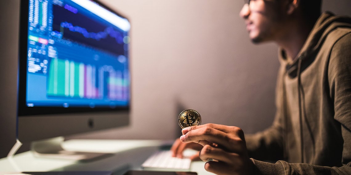 Indian trader checking stock trading data analysis concept working in office with financial graph on computer monitors