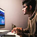 Indian trader checking stock trading data analysis concept working in office with financial graph on computer monitors