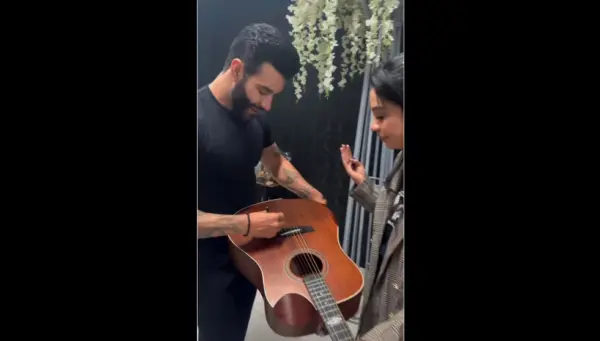 No Acre, Gusttavo Lima autografa violão que será leiloado ao Hospital do Amor; VÍDEO